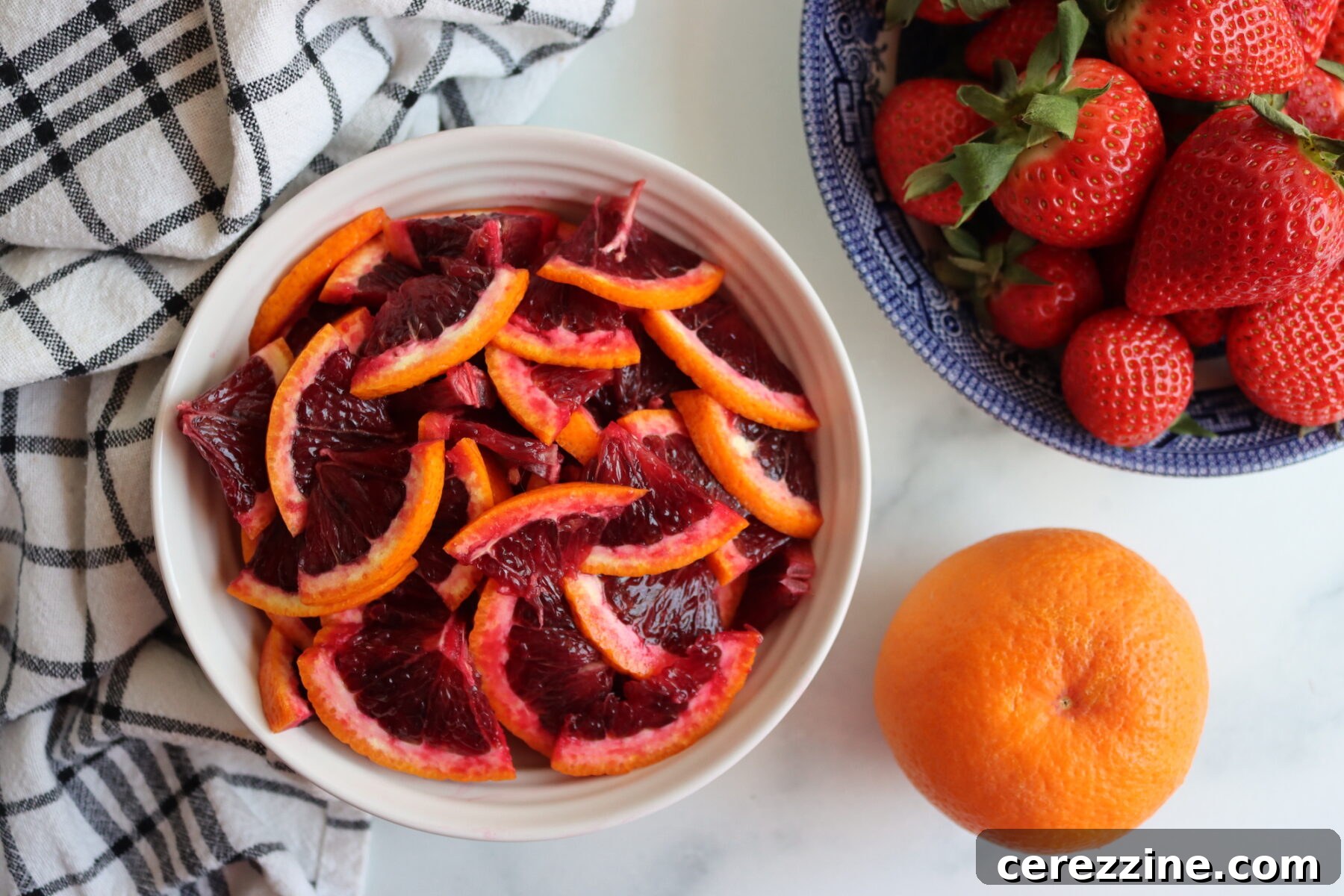 Ingredients for Strawberry Blood Orange Marmalade laid out on a table
