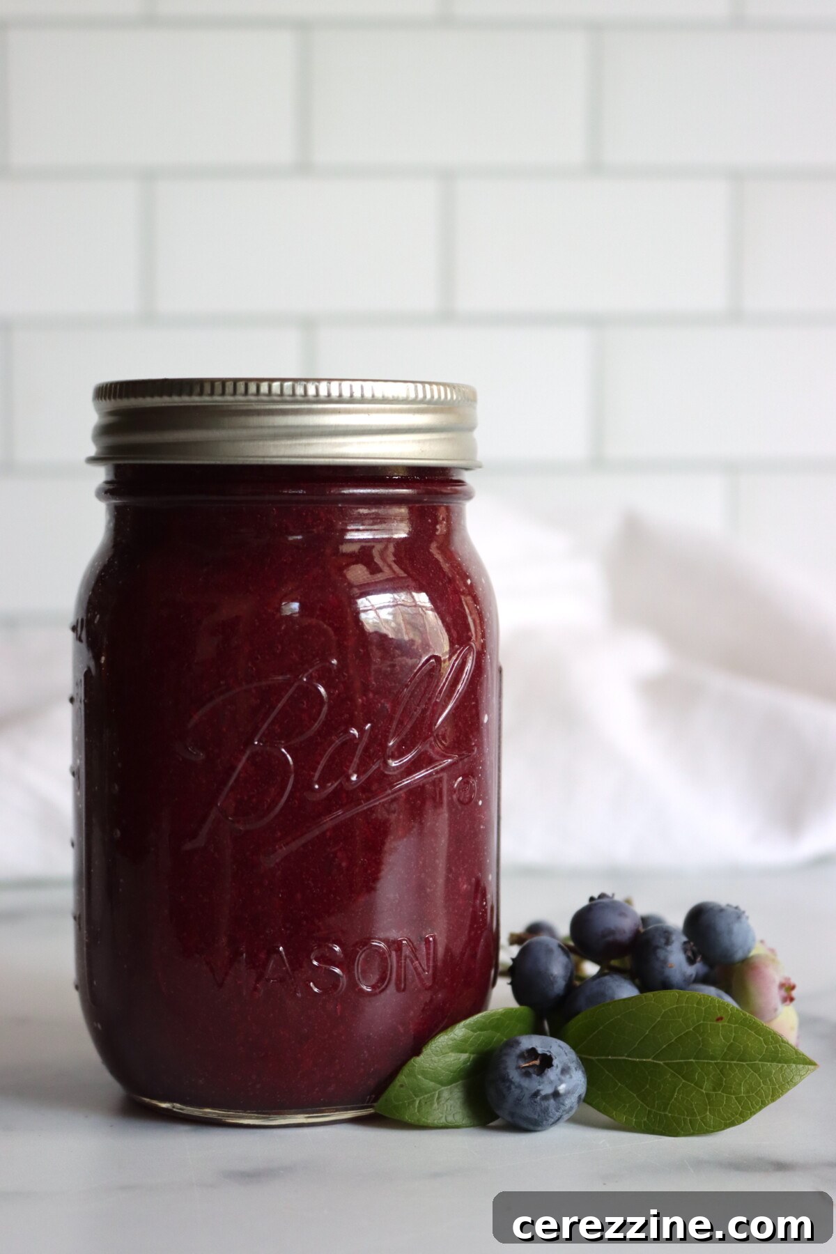 Blueberry applesauce in a jar with a spoon