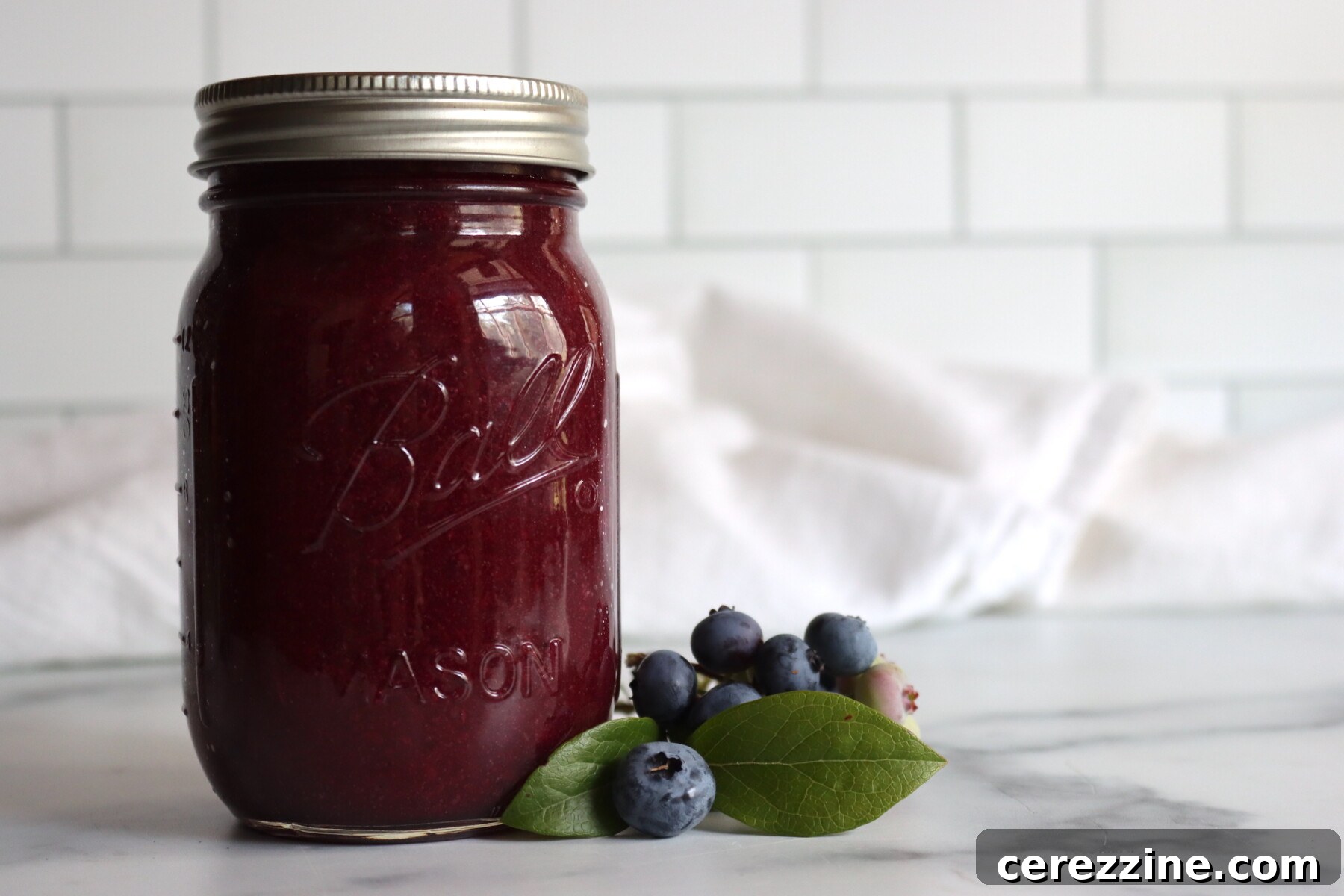 Blueberry applesauce cooking down in a pot