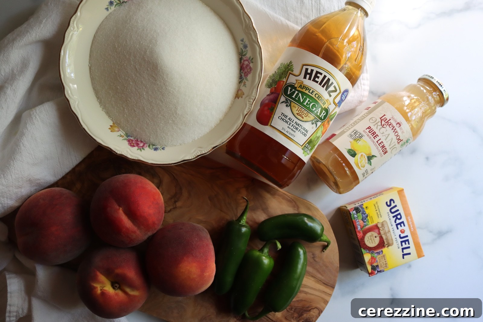 Peach jalapeño jam ingredients: peaches, jalapeños, sugar, cider vinegar, bottled lemon juice, and Sure-Jell pectin