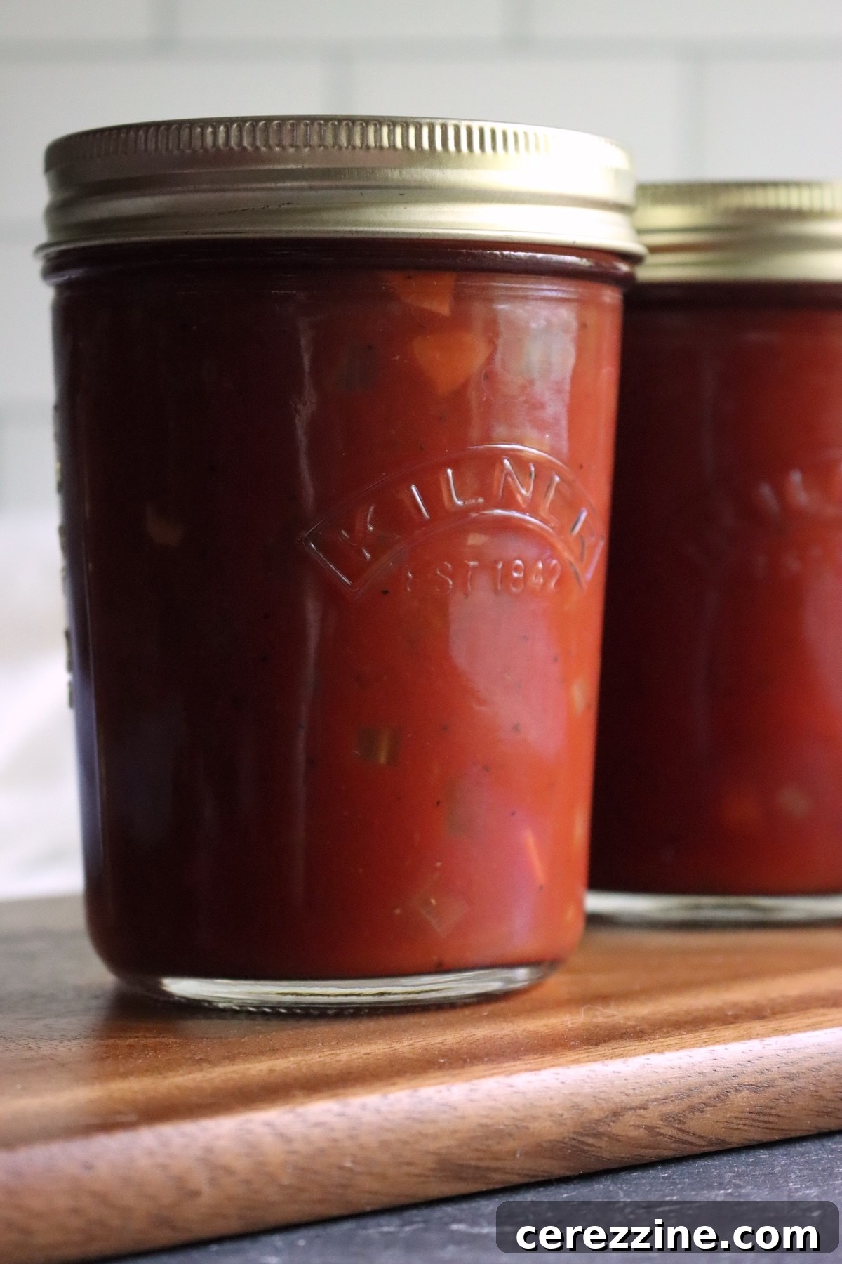 Close-up of a jar of Italian-style tomato sauce with small pieces of carrot and celery