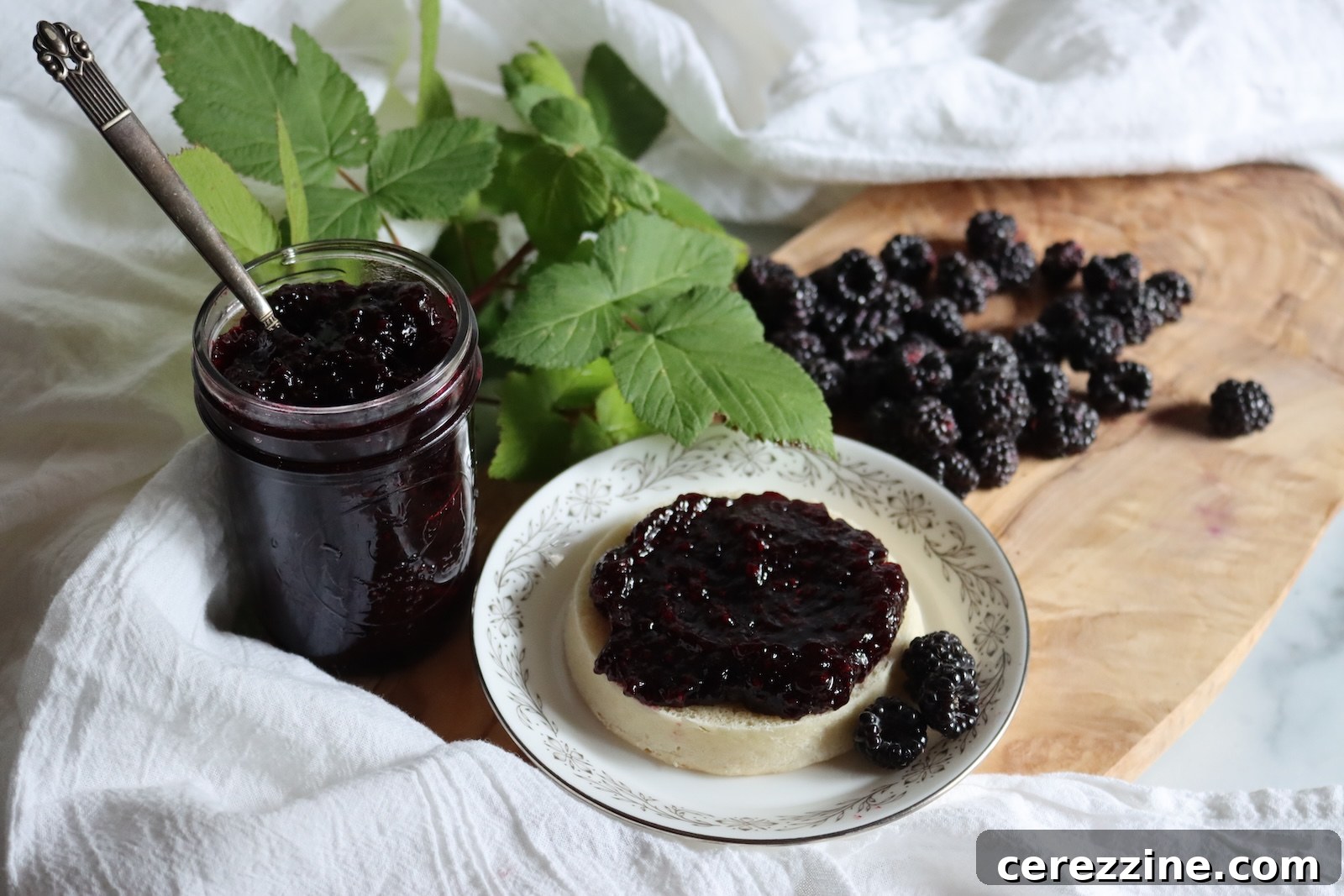 Black raspberry jam with fresh black raspberries and raspberry leaves