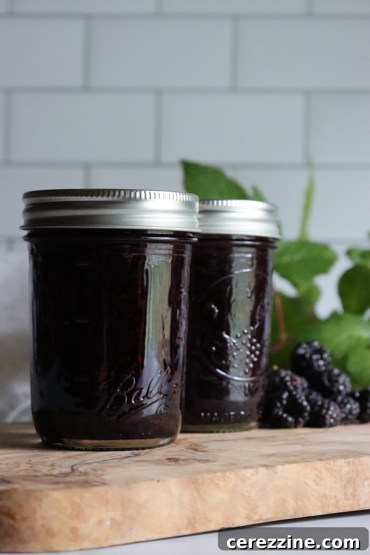 Two half-pint jars of black raspberry jam